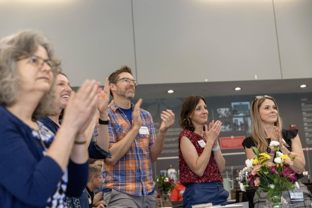Attendees clapping.