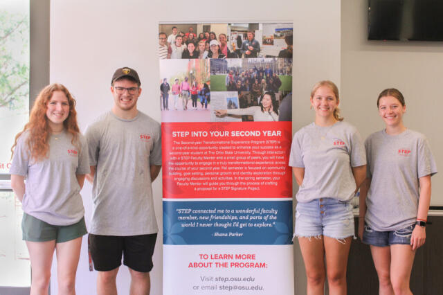 Student Ambassadors Standing in front of a sign at the STEP Open House
